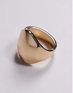 bangle bracelet with large abstract detail in gold tone
