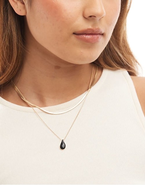 multirow necklace with black enamel charm pendant in gold tone