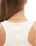 multirow necklace with black enamel charm pendant in gold tone