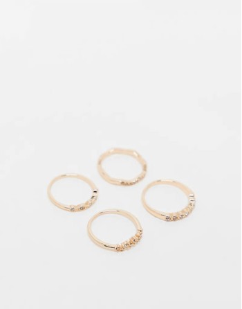 pack of 4 rings with delicate crystal detail in gold tone