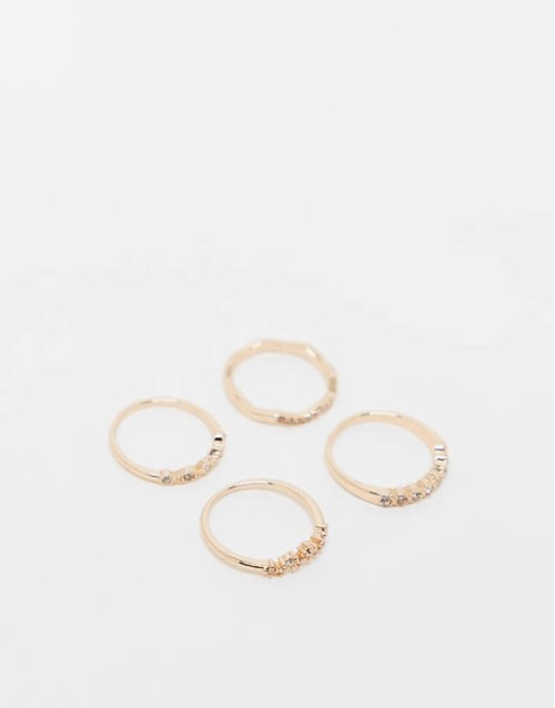 pack of 4 rings with delicate crystal detail in gold tone