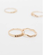pack of 4 rings with delicate crystal detail in gold tone